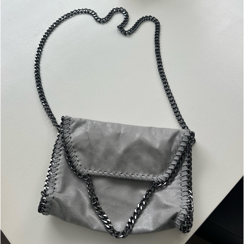 Light gray suede type material Crossbody with chains.